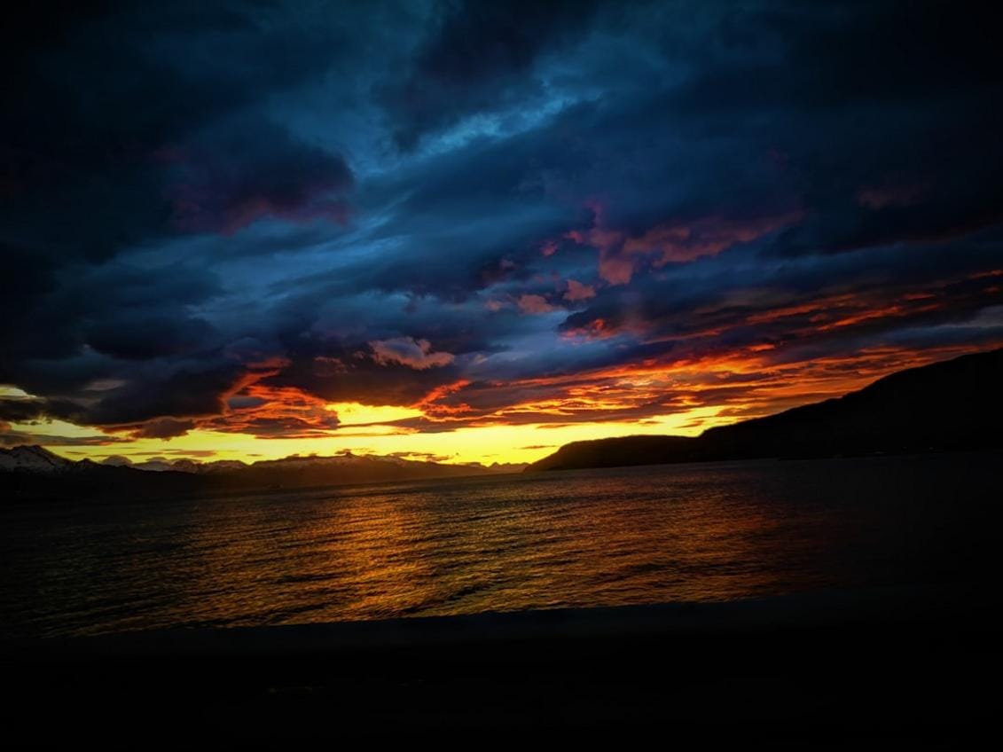 A panoramic view of Antalya's turquoise beaches and surrounding mountains during sunset