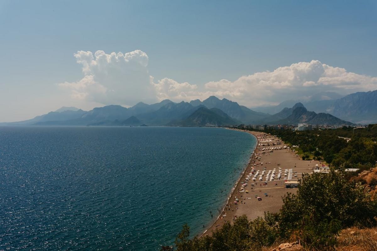 A panoramic view of Antalya's famous clear blue beaches with the historic old town in the background