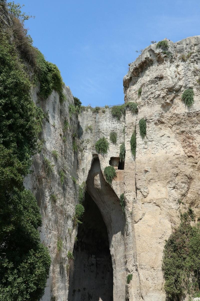 An ancient Roman amphitheater nestled among lush greenery in Antalya